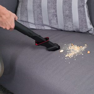 Using the Beldray Turbo Swivel Lite Upright Vacuum Cleaner on upholstery.